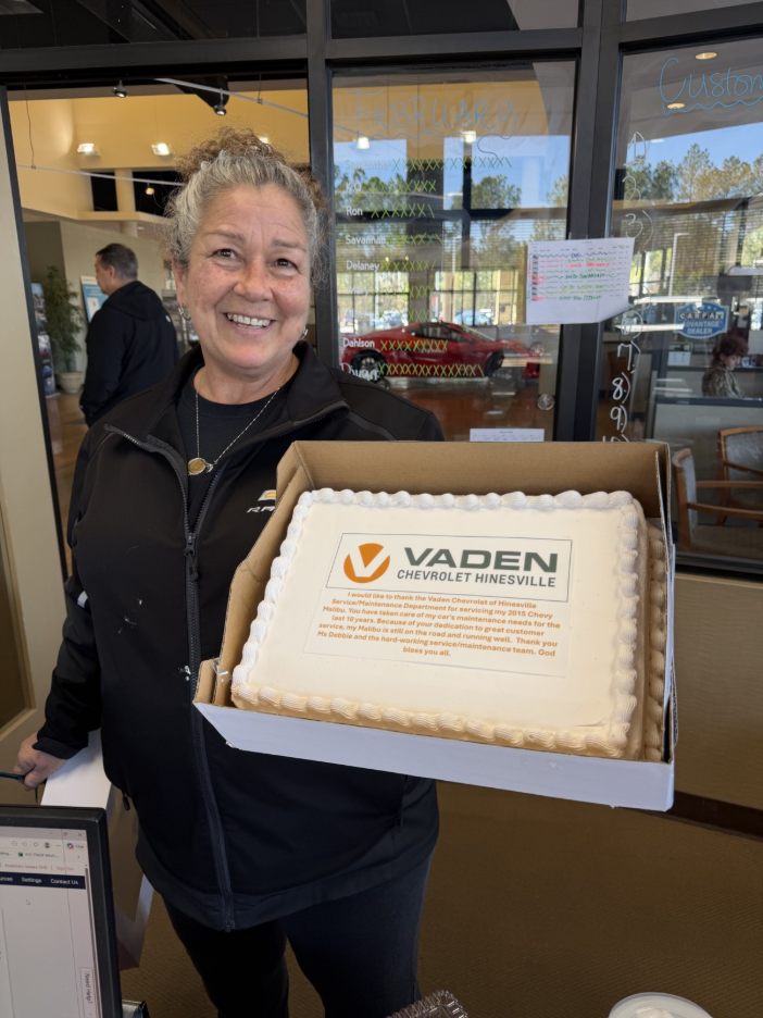 Debbie holding anniversary cake
