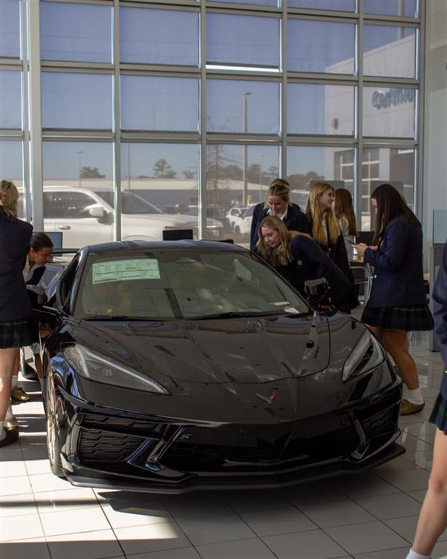 Students learning car buying tips at Vaden Automotive workshop